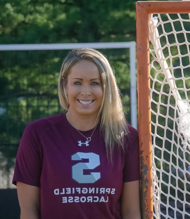 Photo of Jenn Thomas by a lacrosse net